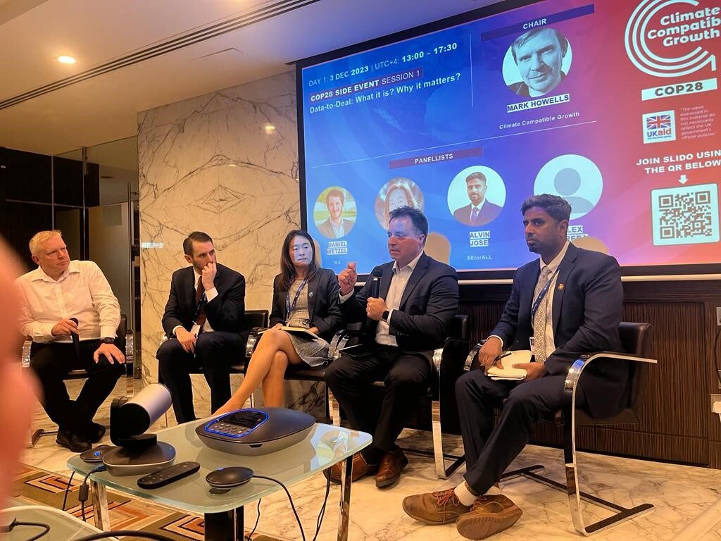 Alex Money at a panel discussion for COP