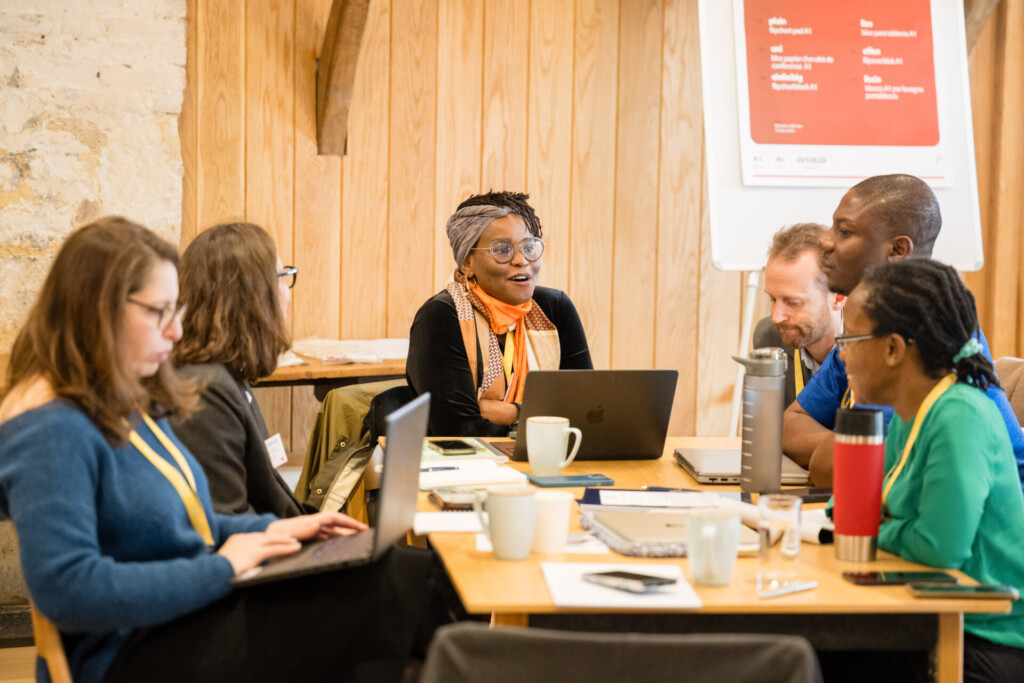 Makena Ireri (centre) talking at a workshop table