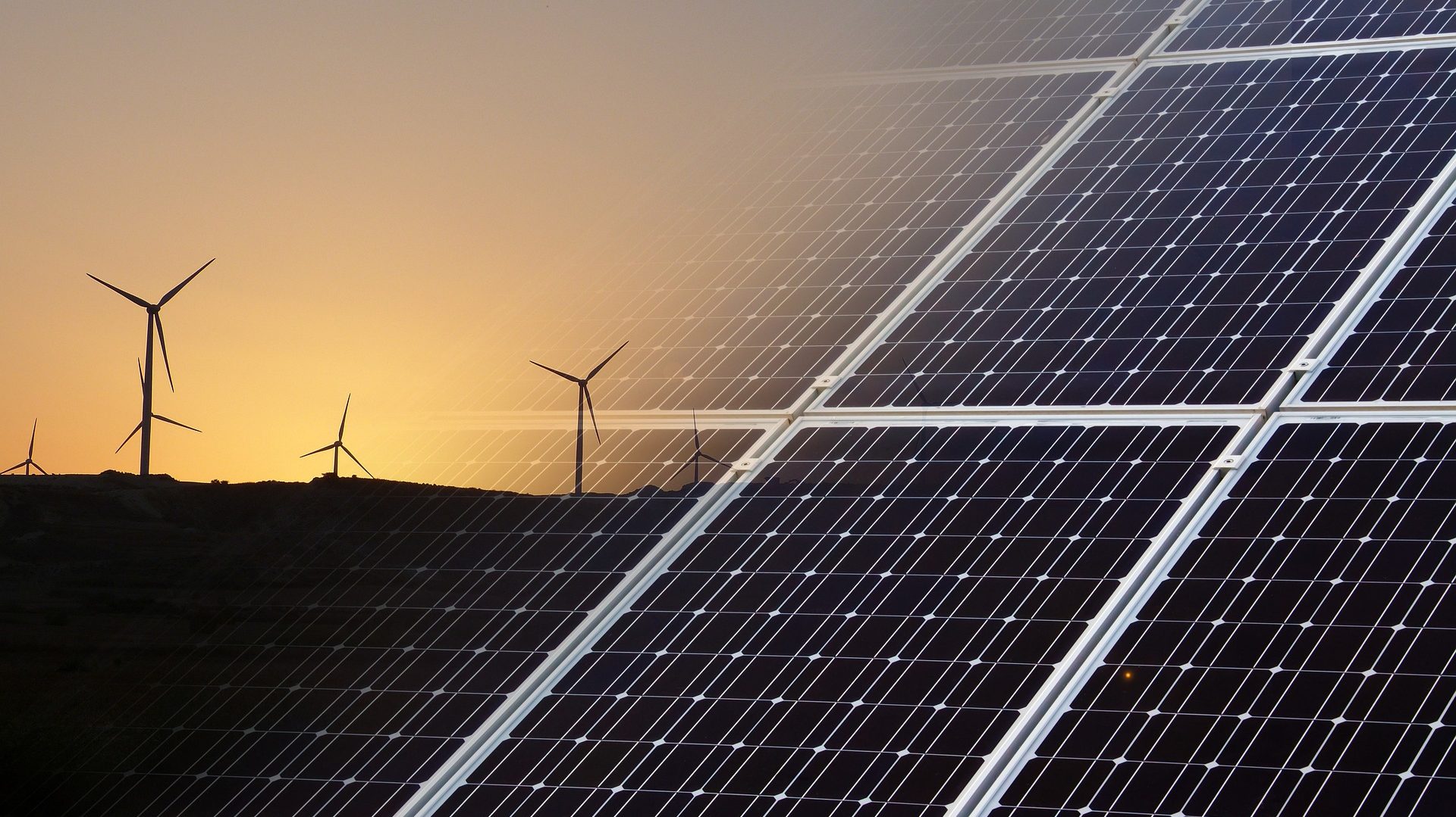 An image that blends wind turbines against a sunset background (left) into solar panels (right) 